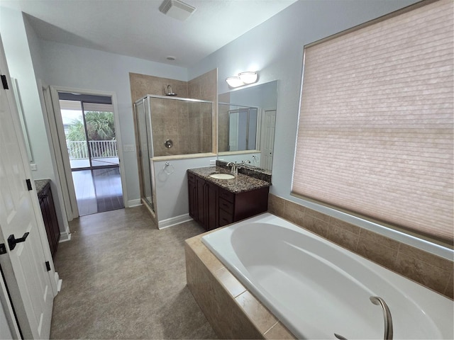 bathroom featuring separate shower and tub and vanity