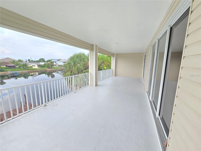 view of patio / terrace featuring a water view and a balcony