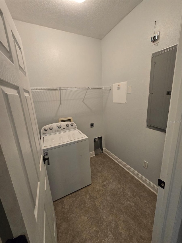 laundry area featuring washer / dryer, electric panel, and a textured ceiling