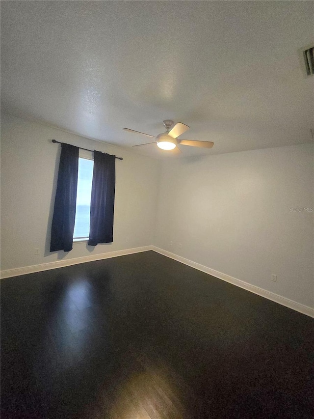 unfurnished room with a textured ceiling, ceiling fan, and hardwood / wood-style flooring