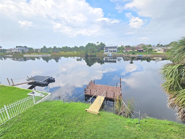 view of dock featuring a yard and a water view