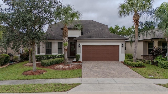 view of front of home with a garage and a front lawn