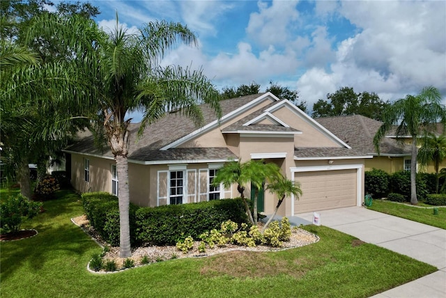 view of front of property with a front lawn and a garage