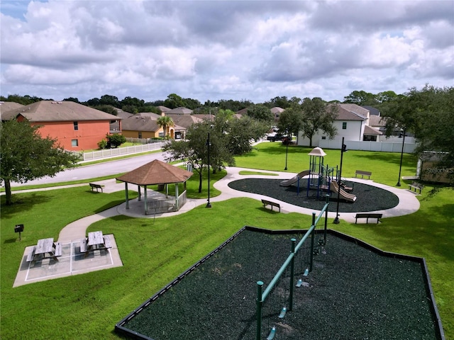 view of property's community with a playground and a yard