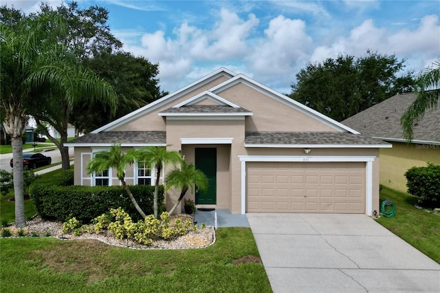 view of front of home featuring a garage and a front lawn