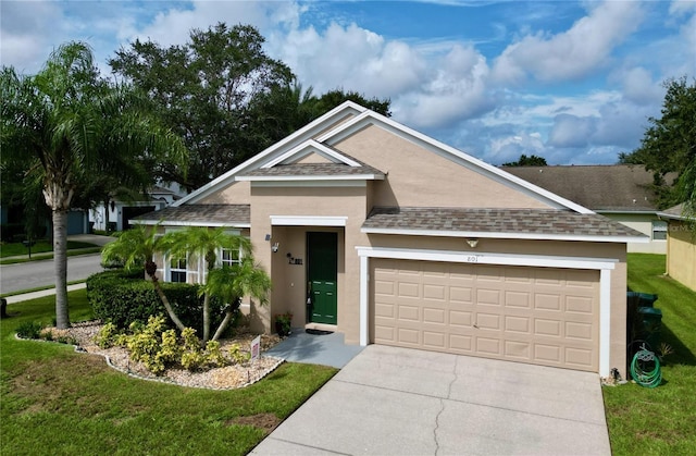 view of front of house featuring a garage and a front lawn