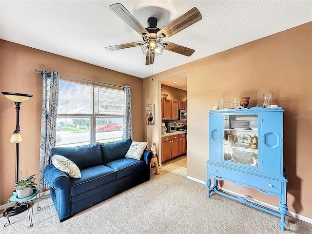 carpeted living room with a textured ceiling and ceiling fan