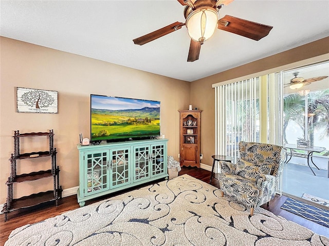 living room with ceiling fan and dark hardwood / wood-style flooring