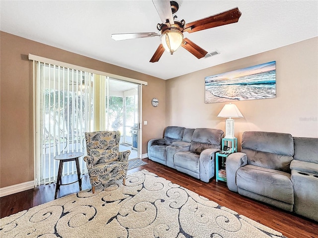 living room with dark hardwood / wood-style floors and ceiling fan