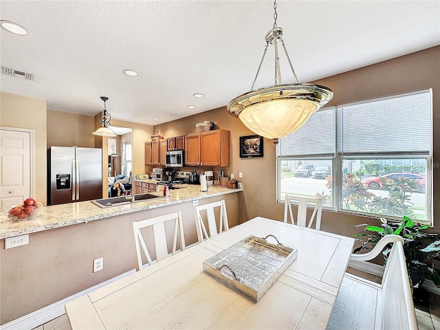 dining space with a textured ceiling and sink