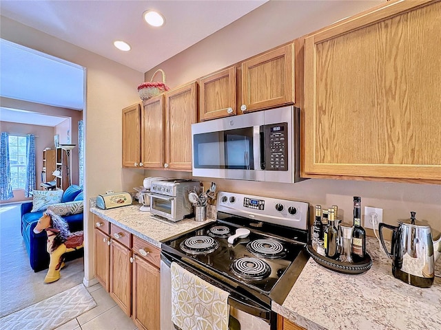 kitchen with stainless steel appliances and light tile patterned floors