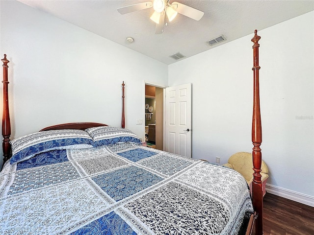 bedroom featuring a textured ceiling, dark hardwood / wood-style flooring, and ceiling fan