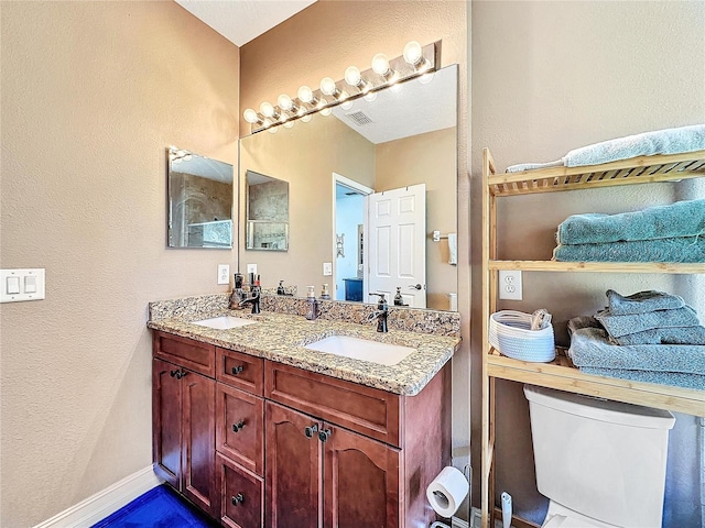 bathroom with vanity and toilet