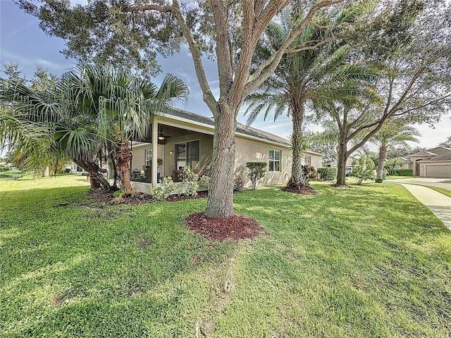 view of front of property featuring a front yard and a garage