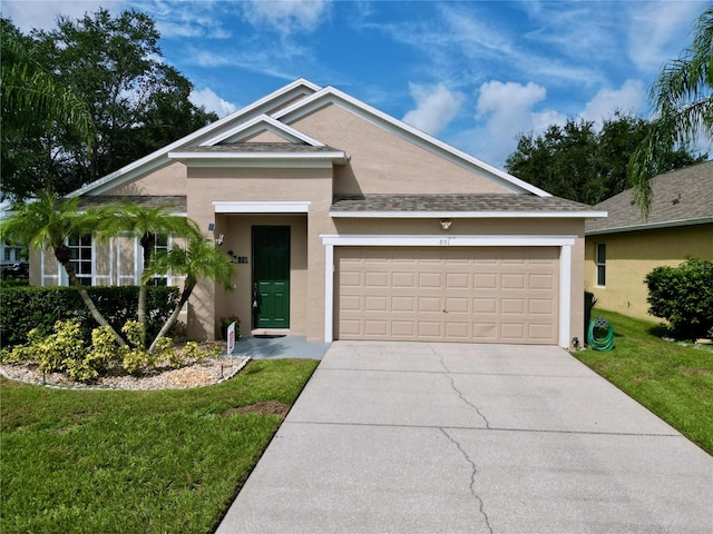 view of front of home with a front yard and a garage