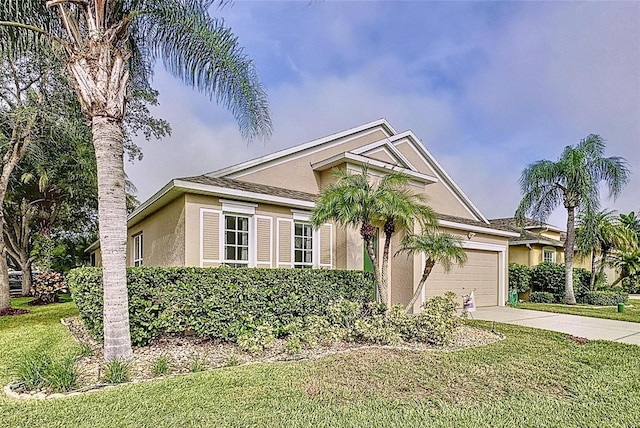 view of front of house featuring a front lawn and a garage