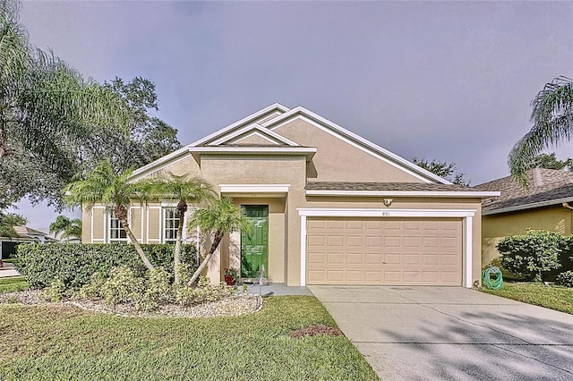 view of front of home featuring a garage and a front lawn