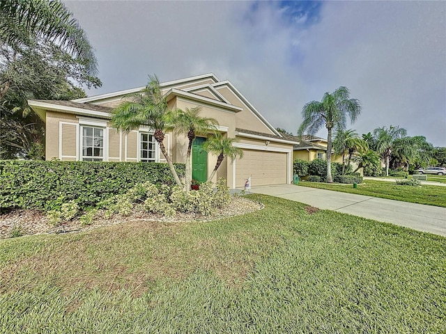 view of front of property featuring a front yard and a garage