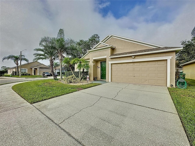 view of front of home with a front yard and a garage