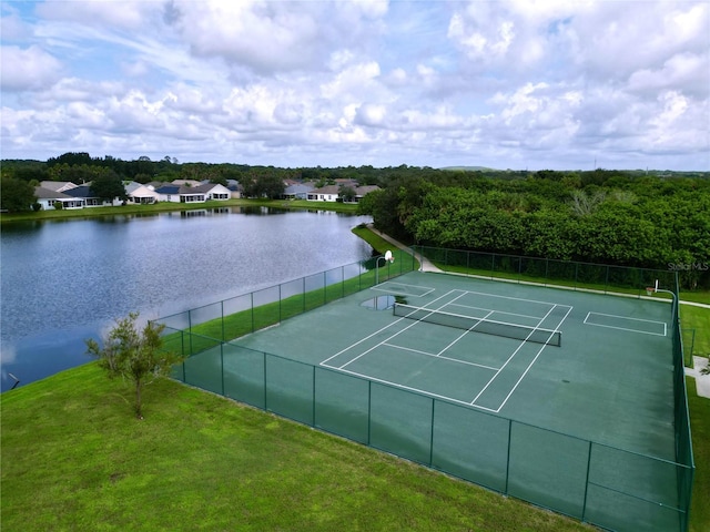 view of tennis court featuring a water view