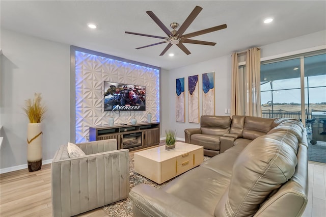 living room featuring ceiling fan and light hardwood / wood-style flooring