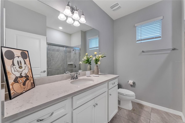 bathroom with a shower with shower door, vanity, toilet, and plenty of natural light