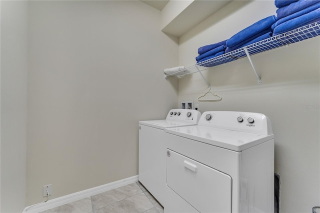 washroom with light tile patterned flooring and washing machine and clothes dryer