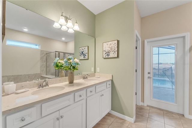 bathroom featuring tile patterned floors, a shower with shower door, and vanity