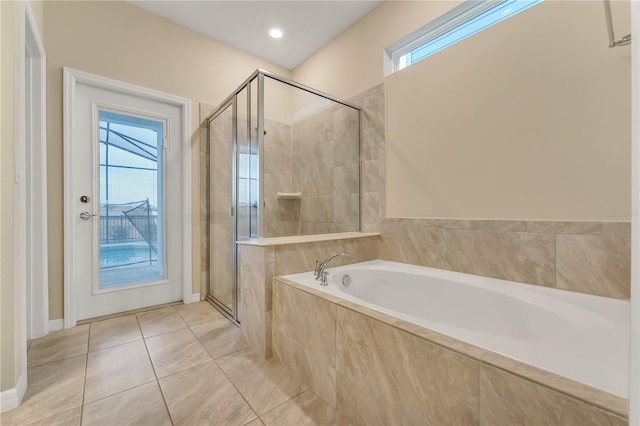 bathroom featuring plus walk in shower, plenty of natural light, and tile patterned floors