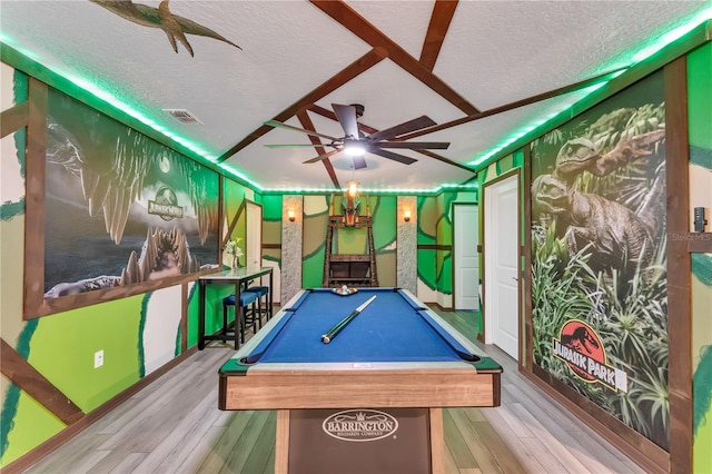 recreation room with a textured ceiling, light hardwood / wood-style floors, ceiling fan, and billiards