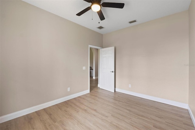 empty room featuring ceiling fan and light hardwood / wood-style flooring