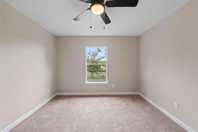 spare room featuring carpet and ceiling fan