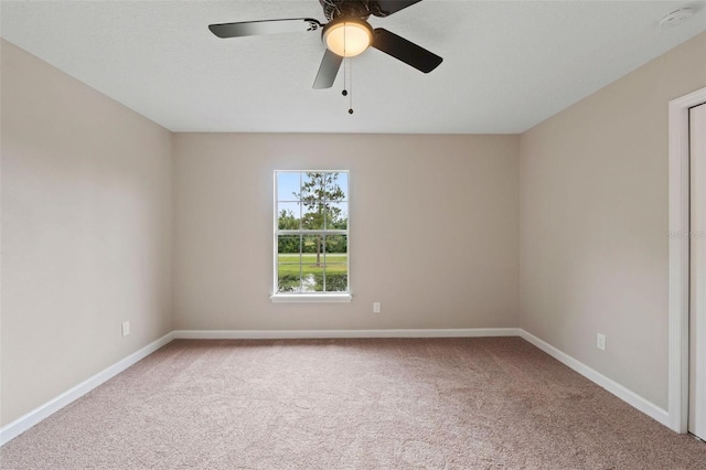 spare room featuring carpet and ceiling fan