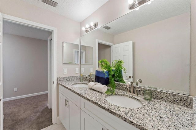 bathroom featuring vanity and a textured ceiling