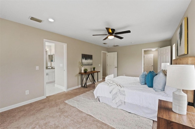 carpeted bedroom with ceiling fan and ensuite bathroom