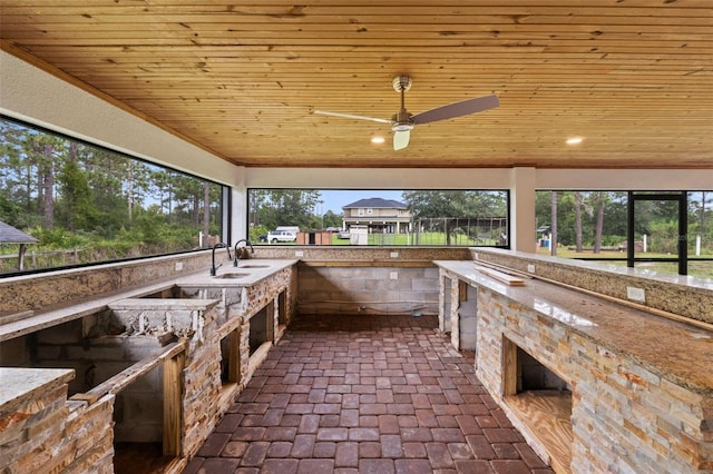 exterior space featuring sink, ceiling fan, and an outdoor kitchen