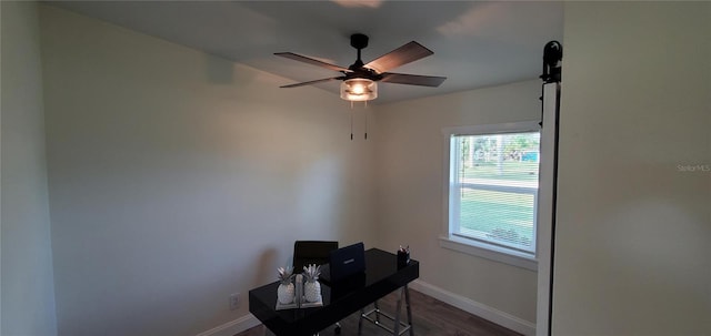 home office featuring dark hardwood / wood-style flooring and ceiling fan