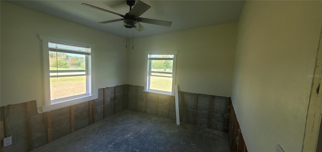 spare room featuring plenty of natural light and ceiling fan