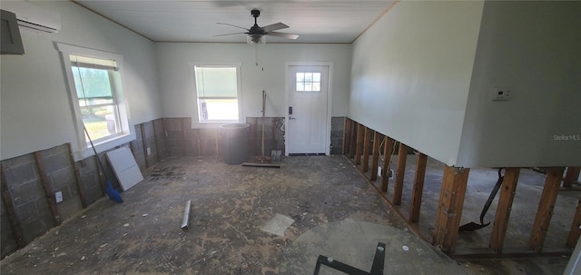 foyer featuring an AC wall unit and ceiling fan