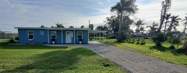 view of front of house featuring a front lawn and a carport