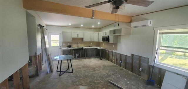 kitchen with ceiling fan, sink, and a wall mounted AC