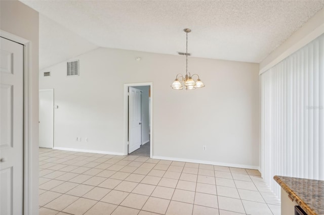 unfurnished dining area featuring a textured ceiling, light tile patterned floors, vaulted ceiling, and a chandelier