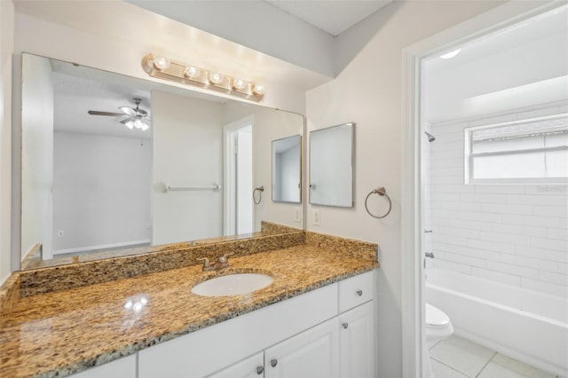 full bathroom featuring tile patterned floors, vanity, ceiling fan, tiled shower / bath, and toilet