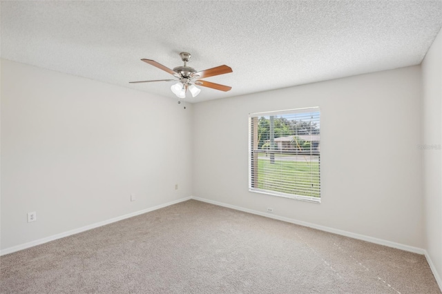 carpeted empty room featuring a textured ceiling and ceiling fan