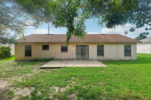 rear view of house with a yard and a patio