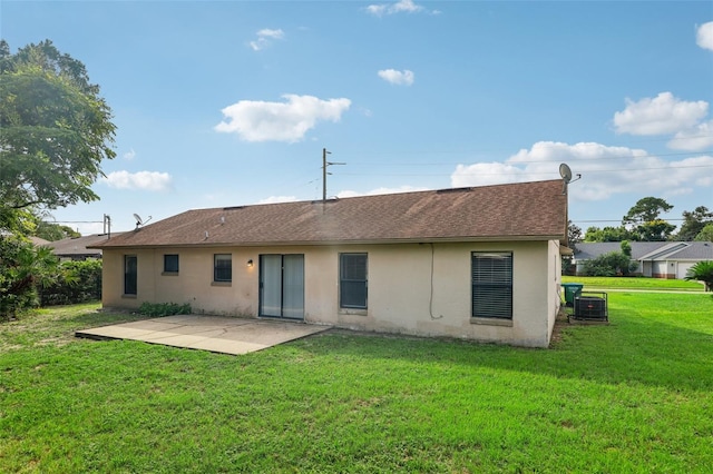 back of property featuring a yard, central AC unit, and a patio area