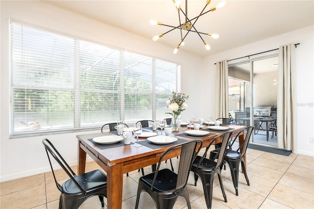 tiled dining space with plenty of natural light and an inviting chandelier