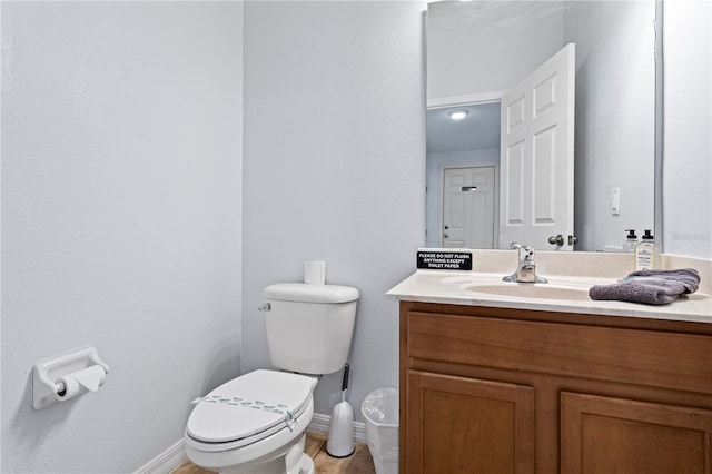 bathroom featuring toilet and vanity