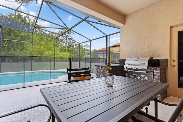 view of patio featuring area for grilling and glass enclosure