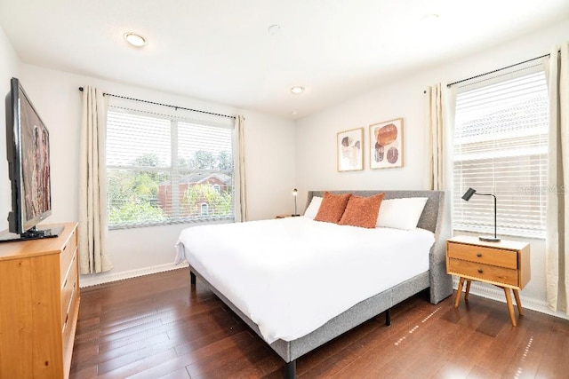 bedroom with dark wood-type flooring